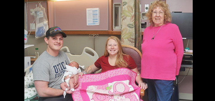 Chenango Piecemakers present quilt to baby born on National Quilting Day